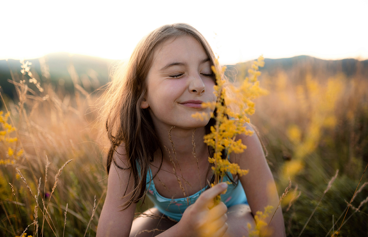 A girl sniffing flowers