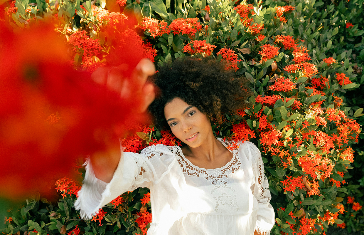 woman lying in a field of flowers