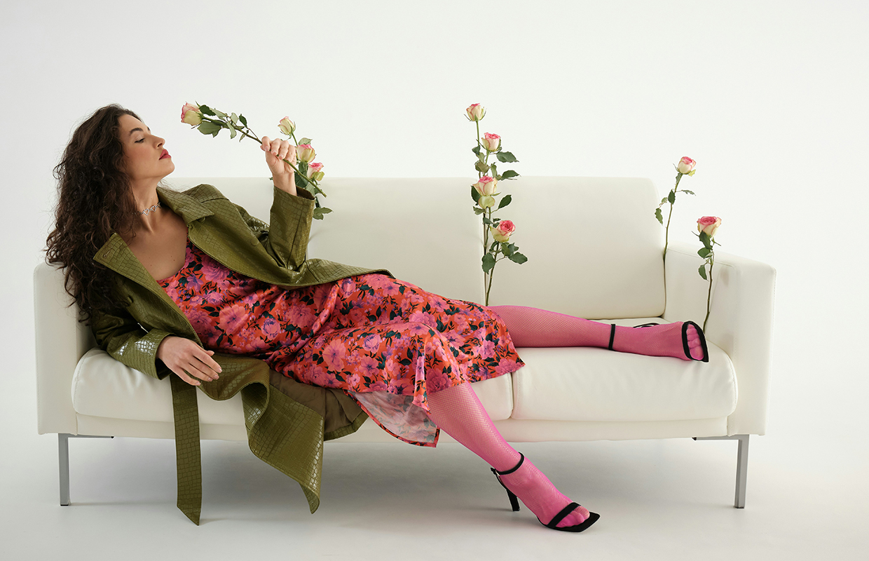A woman lying on a couch holding flowers