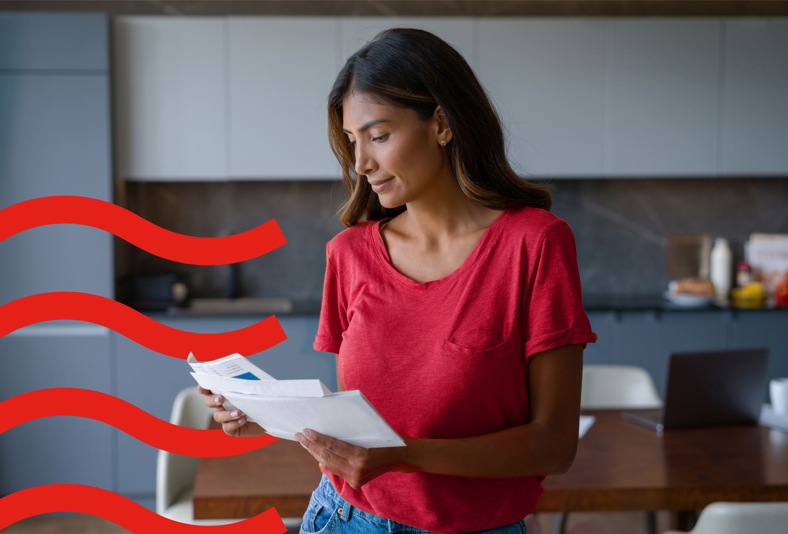 woman looking at letters in the kitchen 