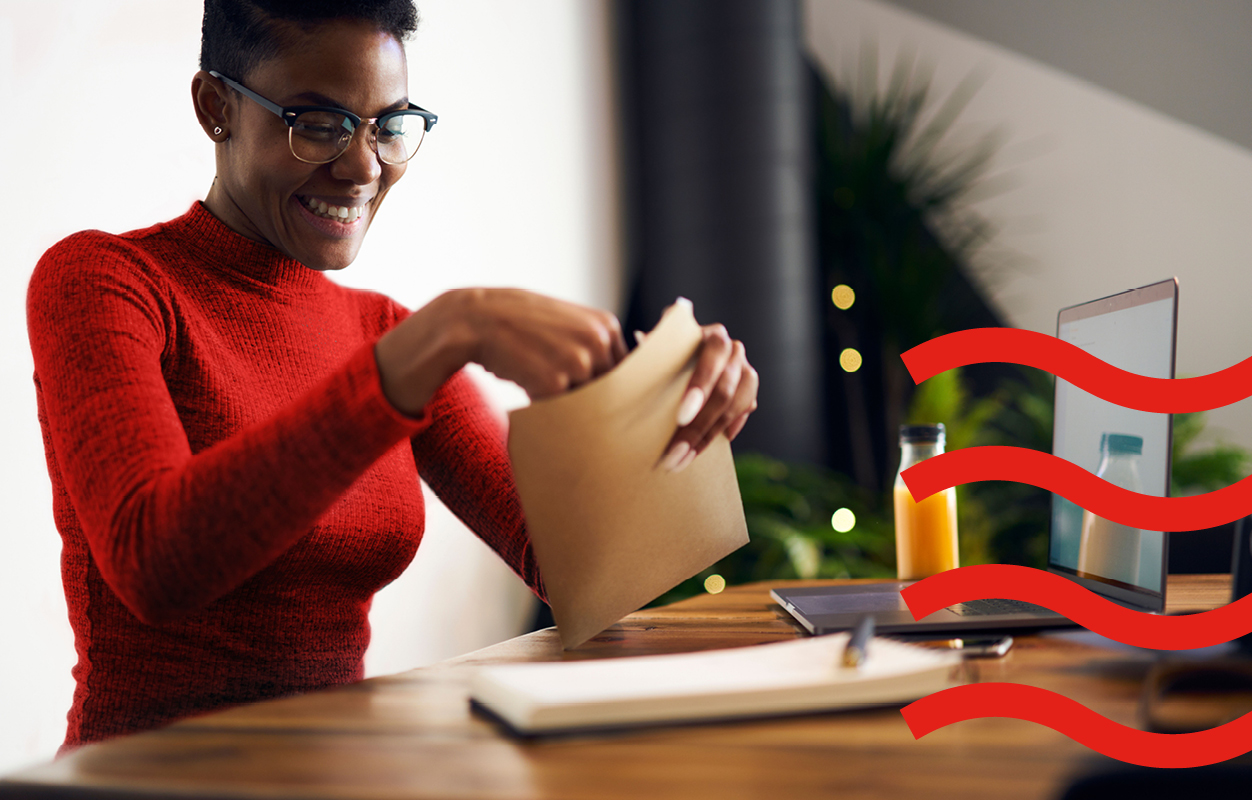 A woman opening an envelop