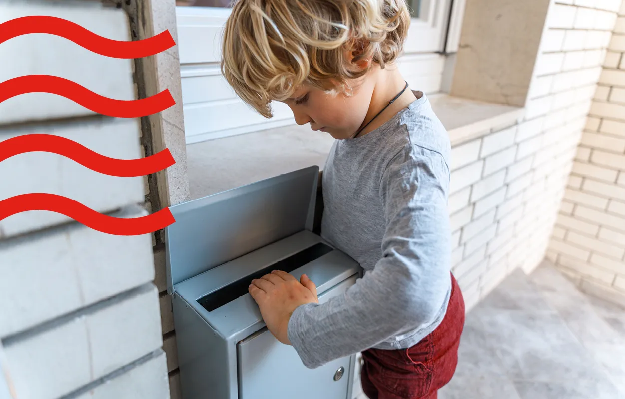 A kid looking inside the letterbox